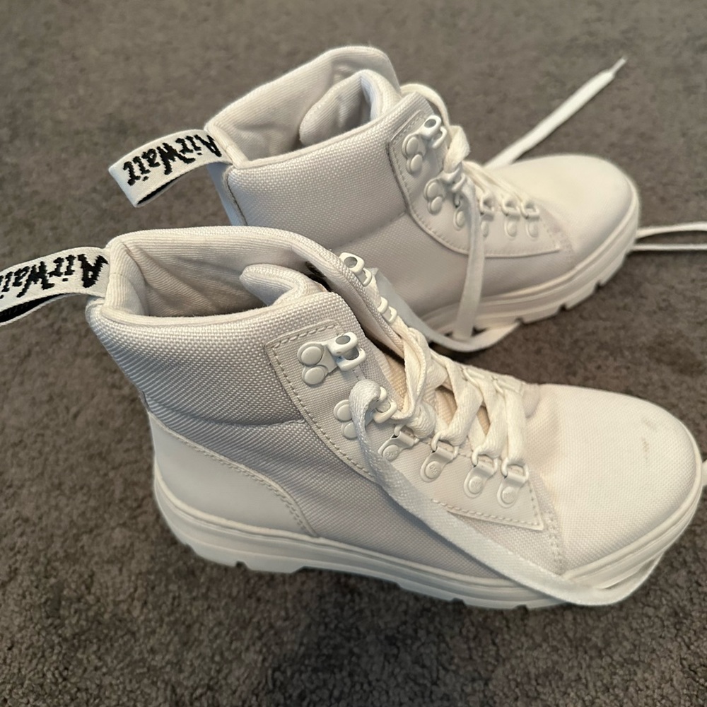 Dr. Martens high top shoes.